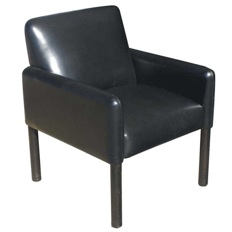 A Mid-Century Modern black leather lounge or club chair with ebonized legs. This chair features styling reminiscent of Mario Bellini.