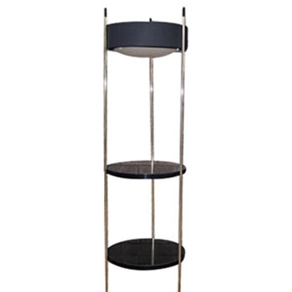 A mid century modern combination lamp and side table made by the Laurel Lamp Company.  A tripod brass frame supporting a perferated black metal light diffuser and two round black laminate shelves.  This versatile piece could be used as a reading