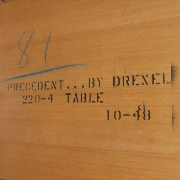 A Mid-Century Modern dining table designed by Edward Wormley for Drexel's Precedent collection. The drop leaf table measures 50