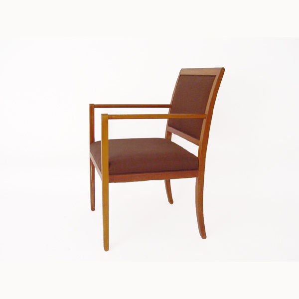 A pair of armchairs designed by Ward Bennett for Brickel. An oak frame and arms with reddish-brown upholstery.