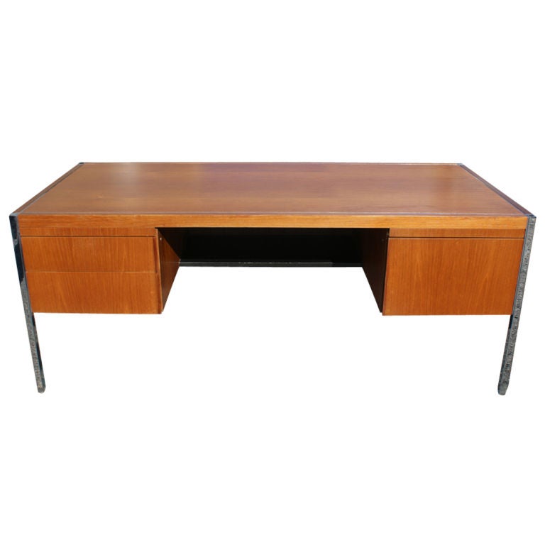 A mid century modern executive desk designed by Richard Schultz for Knoll.  Oak with a chrome frame and legs.  Two pull out writing surfaces, one large file drawer, and two smaller drawers.  As shown in the last picture, we also have a matching desk