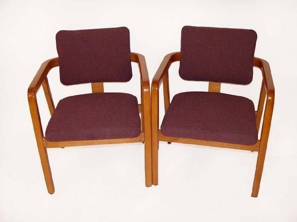 A set of six Mid-Century Modern armchairs designed by George Nelson for Herman Miller. Maple frames with plum colored upholstery. These chairs are also available singly or in pairs.