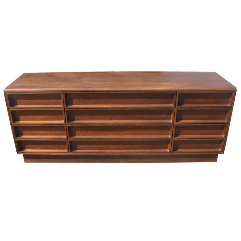 A mid century modern dresser designed by John Keal for Brown Saltman.  Solid walnut construction with twelve drawers.  We have a matching mirror, shown in the last image, which is also available.