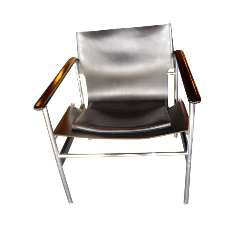 A pair of mid century modern Model 657 Sling Chairs designed by Charles Pollock for Knoll.  Tubular chrome frames with fused epoxy stretchers and arms.  Black saddle leather slings and cushions.