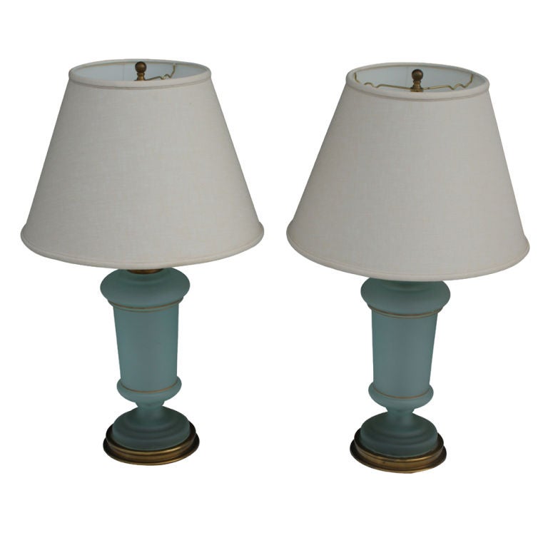 A pair of table lamps designed by Paul Hanson in the 1950's.  Frosted green glass with gold banding and a brass base and fittings.