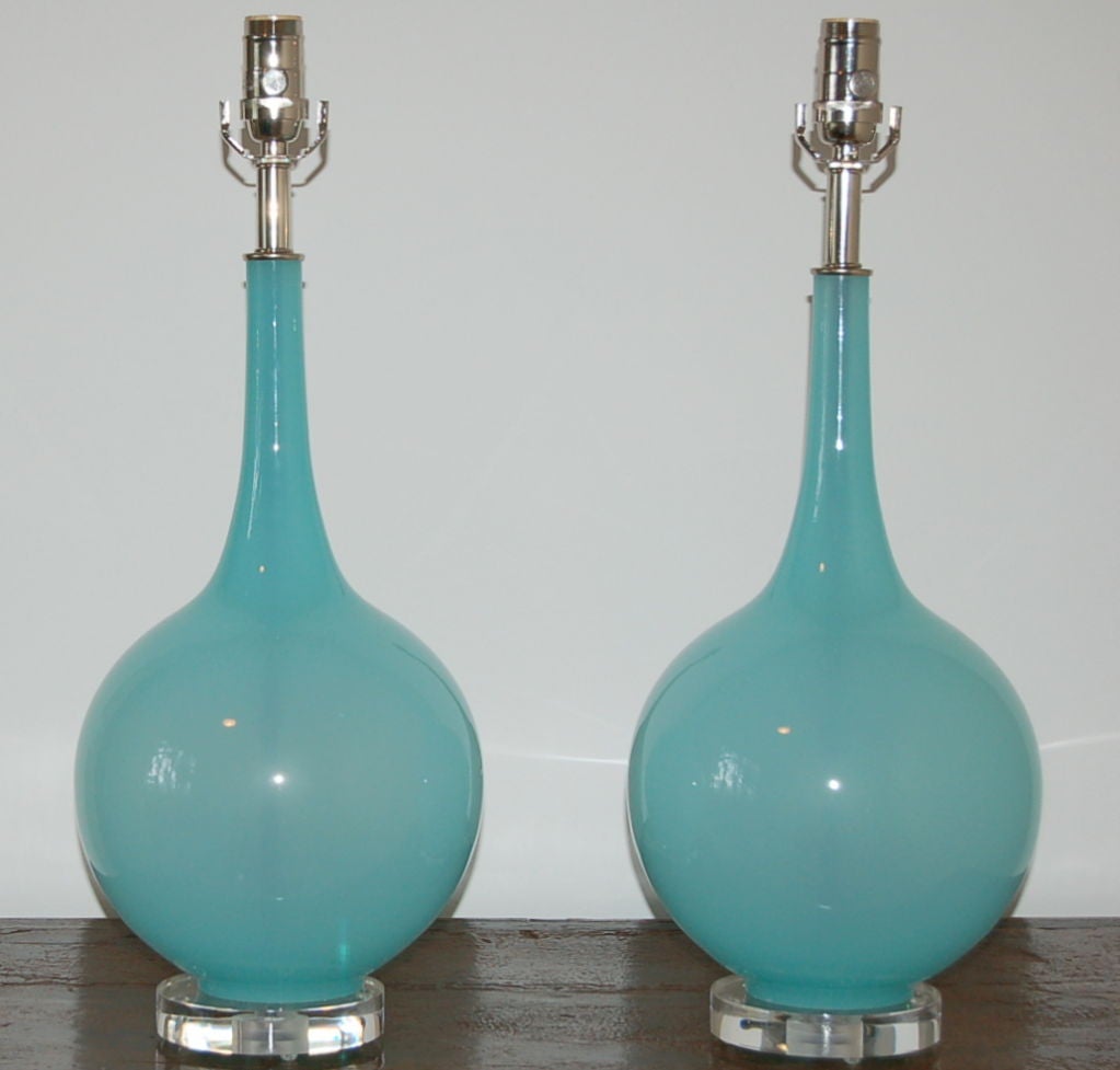 The most sexy, etherial sky blue colored Murano glass table lamps, probably from Seguso in the 1950's.  Mounted on simple lucite bases to show off the beauty of the glass.  Solid brass hardware, nickel plated.  (The color of the lamps is SO