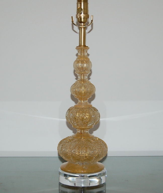 Filled with 24-karat gold and controlled bubbles, this beauty is created by a combination of difficult glass blowing techniques and Classic design. 

The lamp is 22 inches from tabletop to socket top. As shown, the top of shade is 28 inches high.