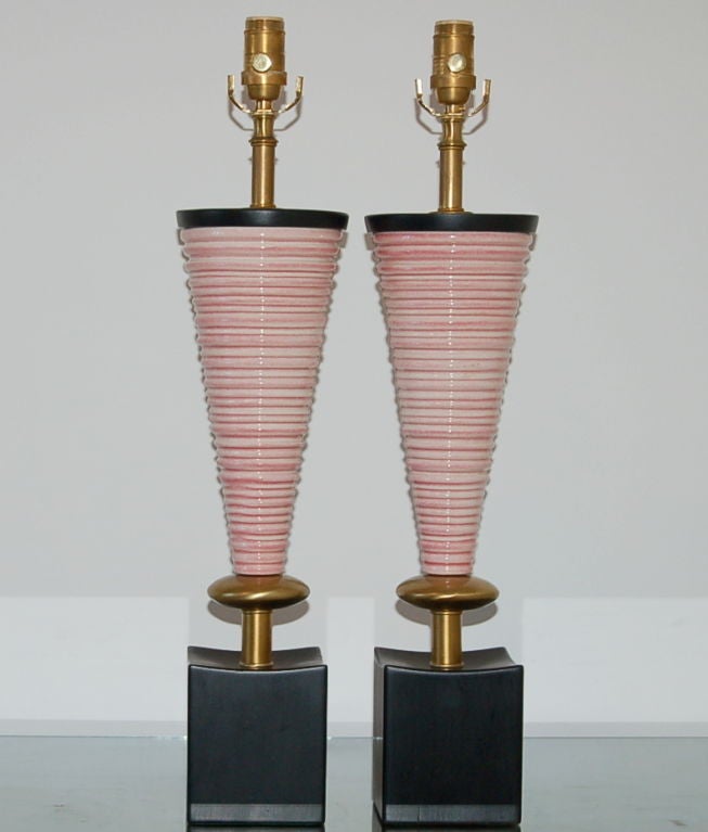 These yummy whimsical sculptures are the color of PEPPERMINT ICE CREAM.  The coils are sandwiched between a satin wafer and a brass toned Mento - mounted on hand rubbed satin black plinths.

The lamps are 25 inches from tabletop to socket top. 