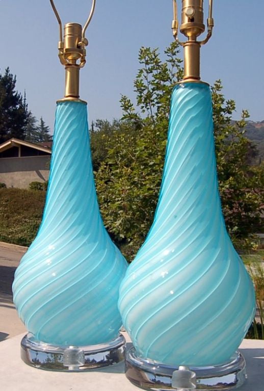 This glamorous pair of vintage Murano lamps in a soft and rich ROBIN'S EGG BLUE. The thickness of the glass ribs give the lamps a striped effect.  

They stand 24 inches tall to the top of the socket.  As shown, the top of shade is 31 inches high.