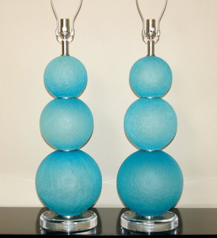 This beautiful pair of sculptured ball Murano lamps is in mint condition. The labels identify them as 'Acqua Marina Ghiacci Satinate' - iced blue-green etched satin glass. The balls, with a semi rough texture to the outside, are joined together by