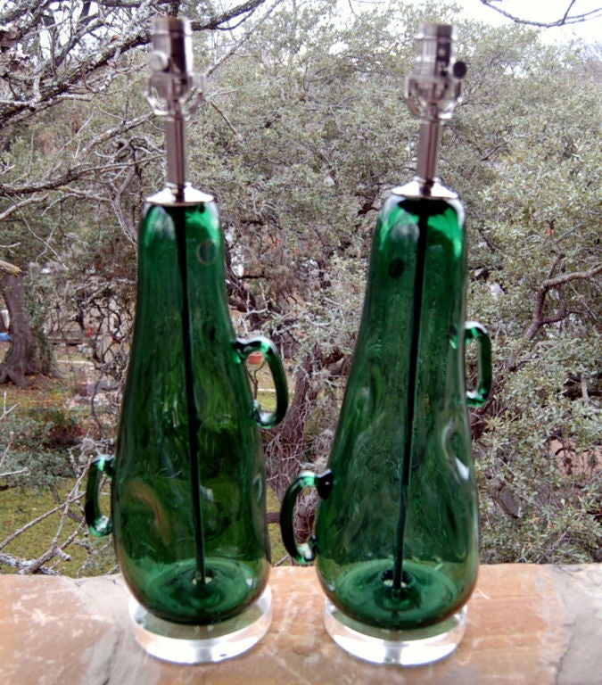 Whimsical dimpled glass lamps with handles - very sculptural. They are DEEP PINE in a wild free-form shape.  Take a close look and you'll see large, almond shaped bubbles.

The lamps are 24 inches from table top to socket top. As shown, the top of