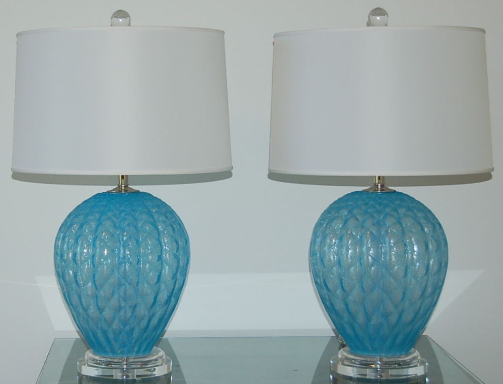 Beautiful BABY BLUE pulegoso Murano lamps blown with a quilted net pattern by Galliano Ferro in the 1950's. Loaded with tiny air bubbles that give the lamp that icy look. Great texture and imposing size - these are quite the chunky pair! 

The