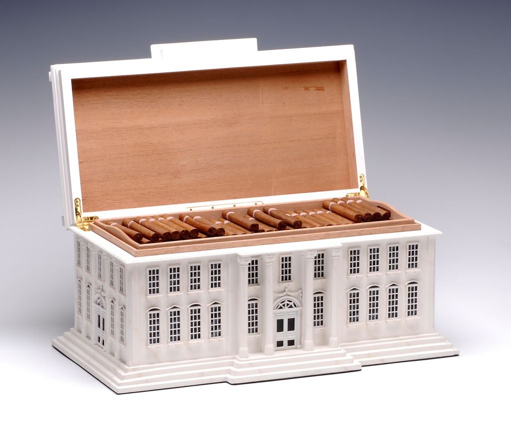A large architectural cigar humidor modelled as the White House, the hinged roof section opening to reveal a cedar lined interior with removeable trays, capacity approximately 250 cigars.