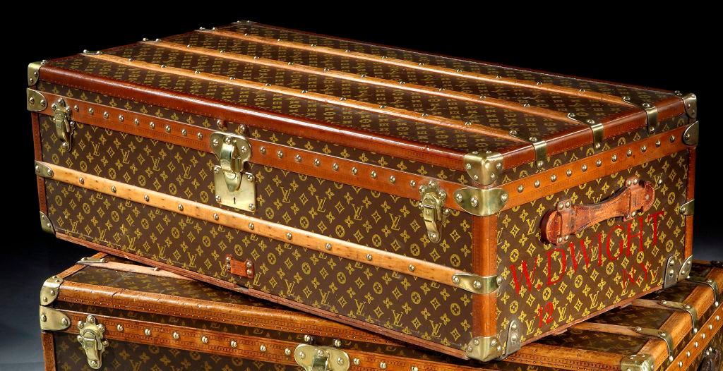 A superb cabin trunk with all brass trim, riveting etc. and leather handles, signed Louis Vuitton. <br />
<br />
Note: The pair to this trunk is also available.