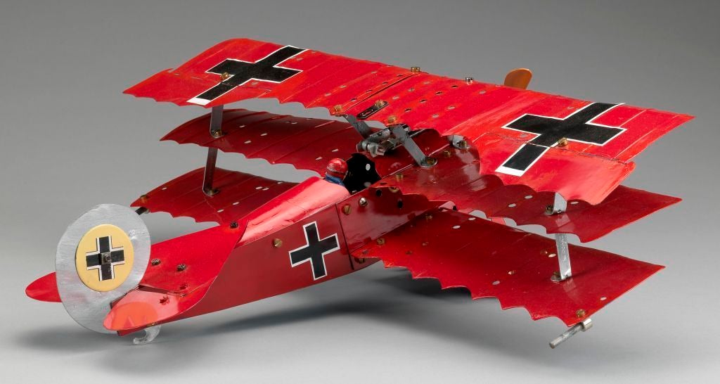 A rare early Meccano model (fully assembled) of Baron von Richthofen's (the Red Baron) 1917 Fokker DR3 ‘Triplane’ complete with all correct markings and pilot sitting in the cockpit. <br />
<br />
Wingspan: 17 inches (44 cms).