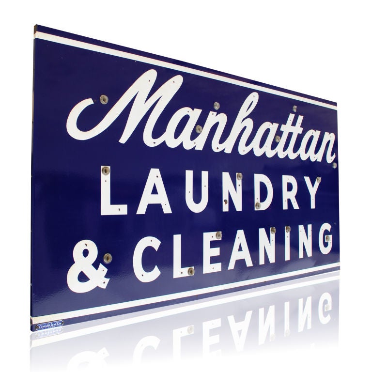 Manhattan Laundry & Cleaners<br />
This is a large porcelain face neon can sign from the 1940-1950's era. Originally all lettered in Neon, this sign is in exceptional condition and still retains that wonderful glossy porcelain finish.  The white