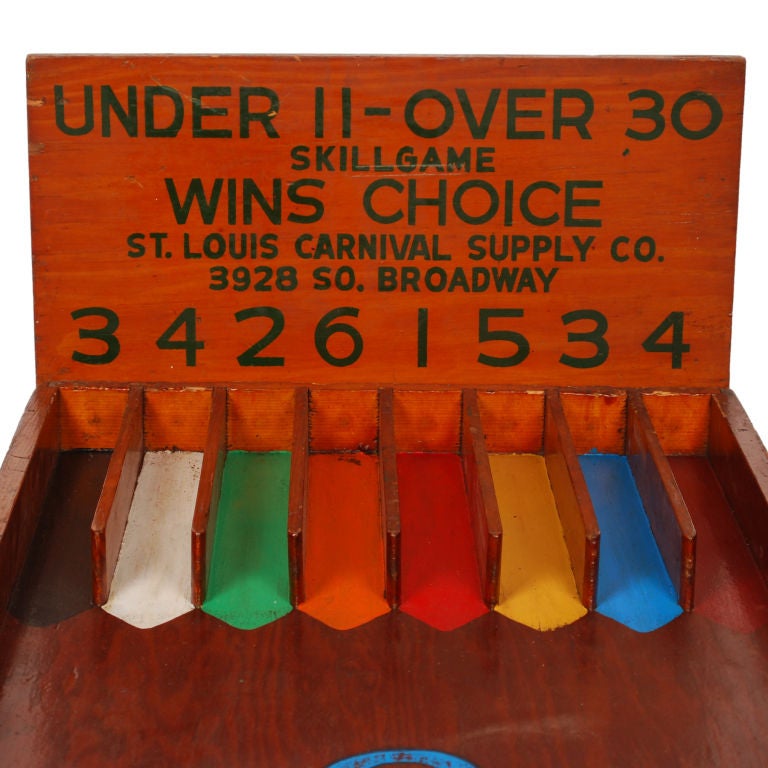 This is a really cool vintage Carnival Game of Skill where you roll the balls down the gameboard and and try to score under or over for Choice of prizes. This large gameboard with original scoreboard was made by the St. Louis Carnival Supply