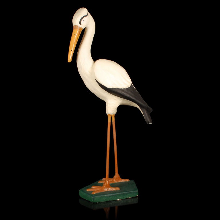 This is a fabulous vintage store display of a large Stork. This wonderful figural display piece was most likely used in a maternity or baby dept in a department store. The bird is made of paper mache , the legs are wood and the base is