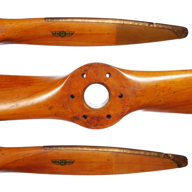 This is an authentic wood Airplane Propeller from the 1940's era. The prop is all original and still retains it Sensenich Propellers Gold Flying Wings decal. The prop is made of laminated birch wood and the leading edges and tips are hand formed in