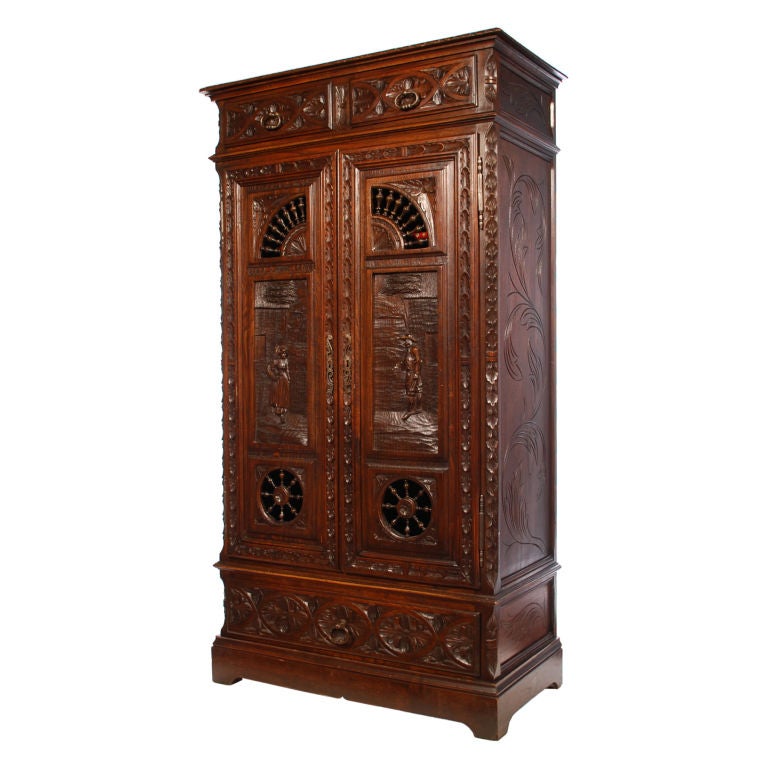 This is a beautifully hand-carved 19th century double door cabinet from the Brittany region of France. It's carved top to bottom and on both sides. There are three drawers on the outside and three adjustable shelves on the inside.<br />
<br