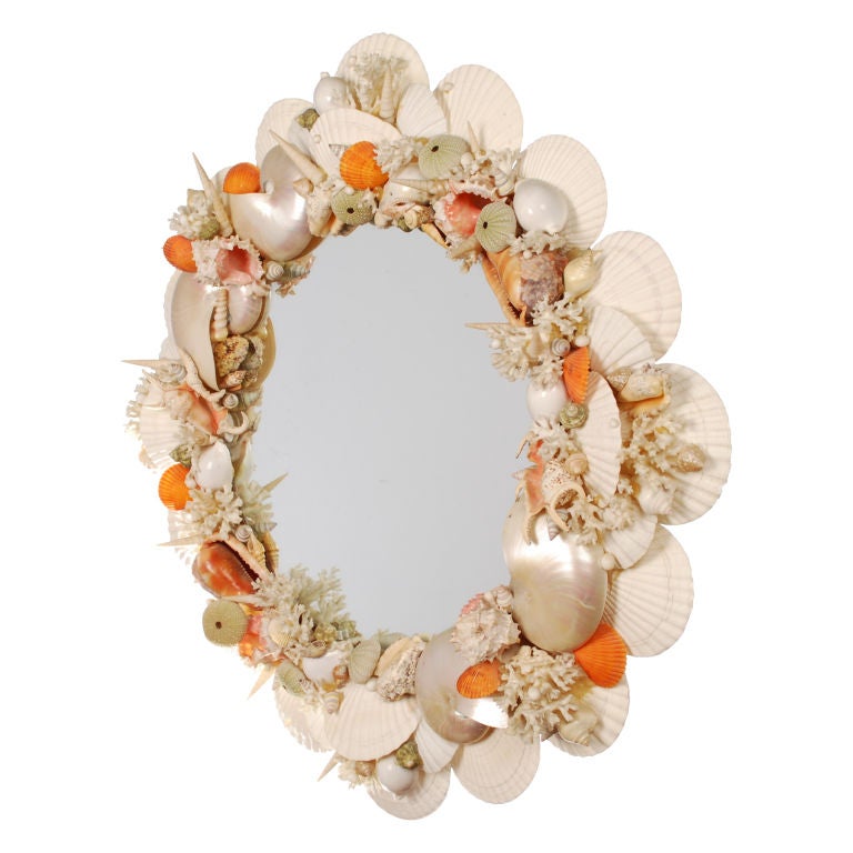 This is a fabulous and colorful handmade Seashell framed Mirror that would be perfect for a Beach house or an elegant Powder room. The wonderful collection of shells include Orange Pecten, Pearlized Nautilus, Coral, Tritons, Turbos, Scallops,