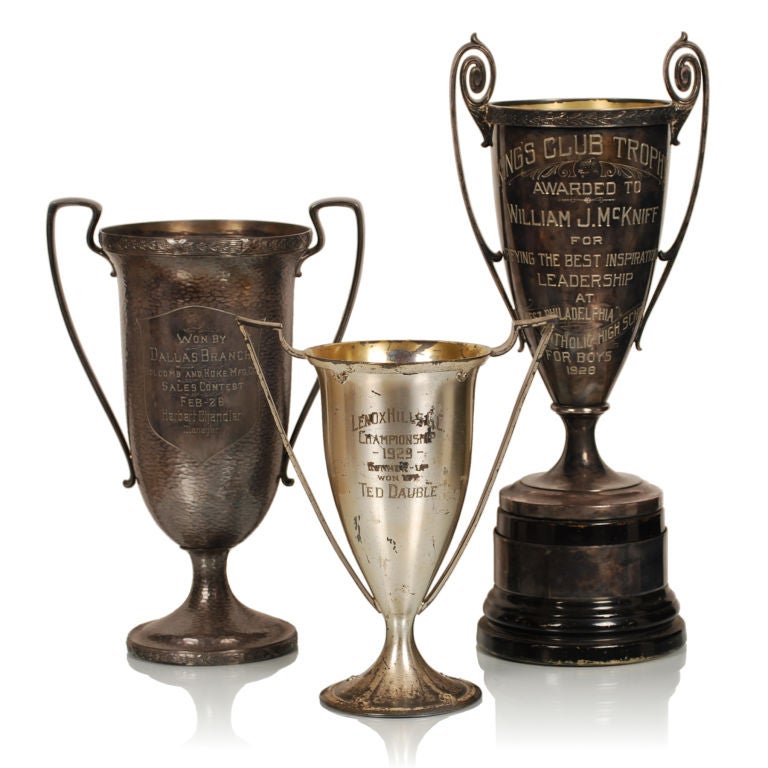 Very nice collection of three large authentic Loving Cup Trophies from the 1920's era. All are beautifully engraved and have a natural worn patina to the silver-plate finish. Each of the trophies has its own unique characteristics in design, details