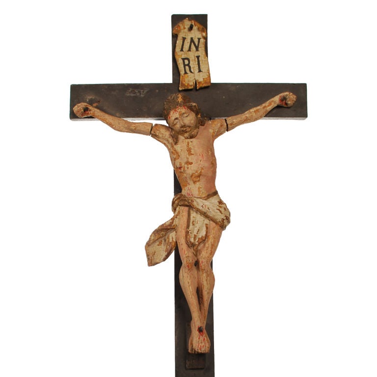 Cristo Crucificado This antique Crucifix with its marvelous figure of Christ is superbly carved and retains almost all of its original paint. This piece most likely originated from Mexico or South America in the late 1800's. We believe it made its