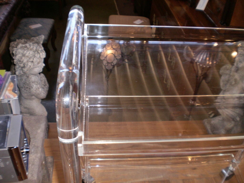 CHIC LUCITE/ACRYLIC THREE TIERED ROLLING BAR CART RESTING ON FOUR CHROME CASTERS
