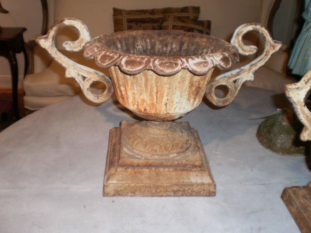 Great pair of French cast iron planters/jardinieres with handles on plinths.

Please click KIRBY ANTIQUES logo below to view additional pieces from our vast inventory.