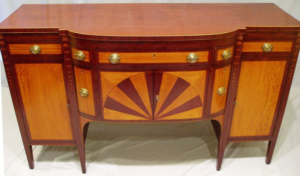 Inlaid Hepplewhite sideboard with 7 drawers (2 wine drawers) and 4 doors into 3 shelved compartments.  D-front center section.  Mahogany with veneers & inlays of mahogany, boxwood, ebony, and beeswing pattern satinwood. Original back.  New French