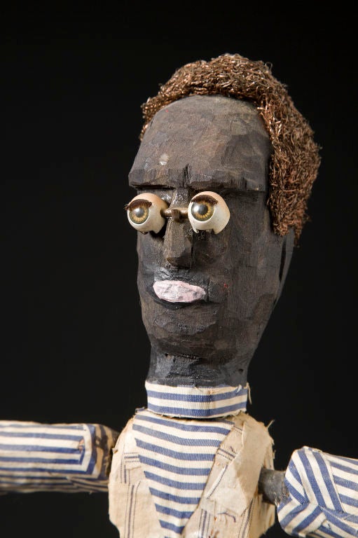 Doll Eyes<br />
By Harvey Peterson<br />
Articulated snap doll sculpture made of wood, polychrome and fabrics: cotton glen plaid and ticking with fiber hair.