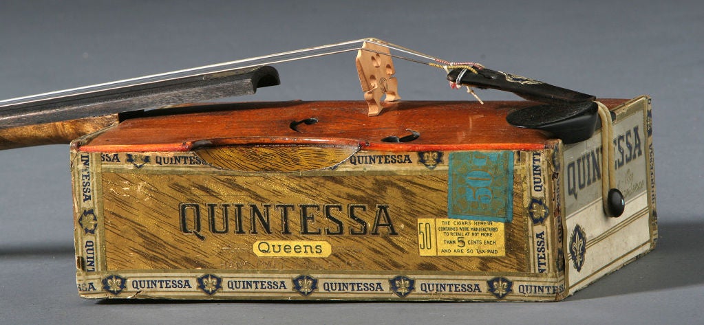 Cigar Box Violin<br />
Signed by J. L. Michels -Deluxe Model #6<br />
Dated 6/12/29<br />
Made from a Russian Quintessa cigar box, neck of violin is a faux tiger maple design.