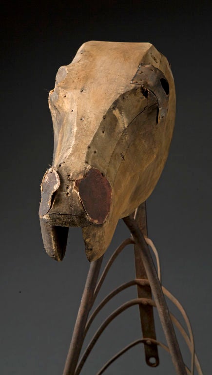 Horse Head mounted on metal frame.
Anonymous maker.
Appled pieces of wood with original remaining polychrome. 
Tin appled to one eye and canvas oil cloth applied to nose.