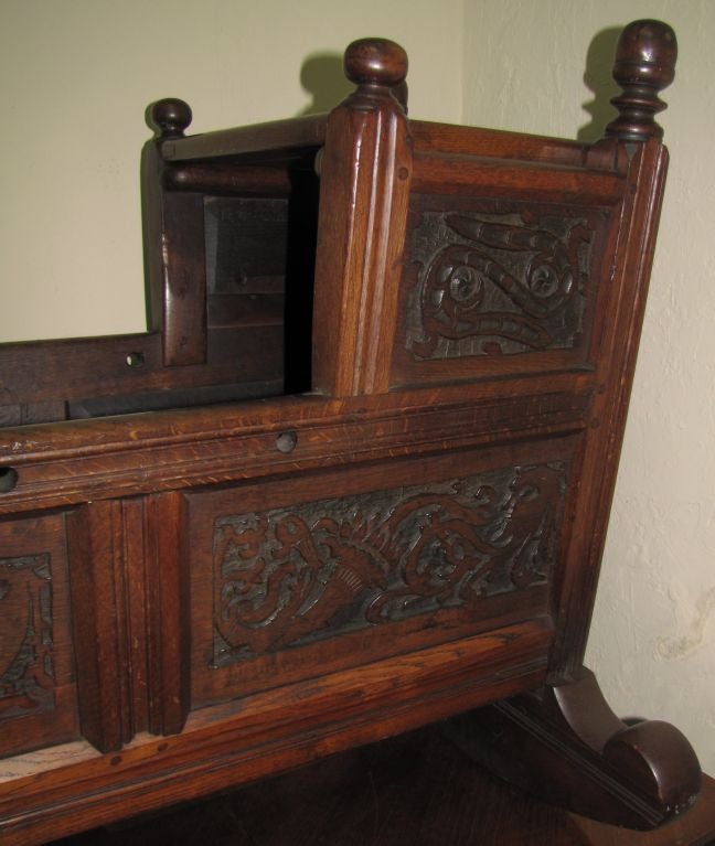 Jacobean style carved oak cradle, outside of the headboard is carved: I W BOR and dated JEN 18 1685 with peg construction. 

 