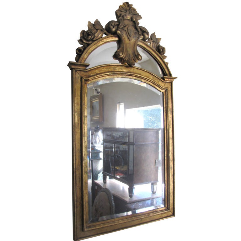French carved gilt-wood mirror with a carved crest.