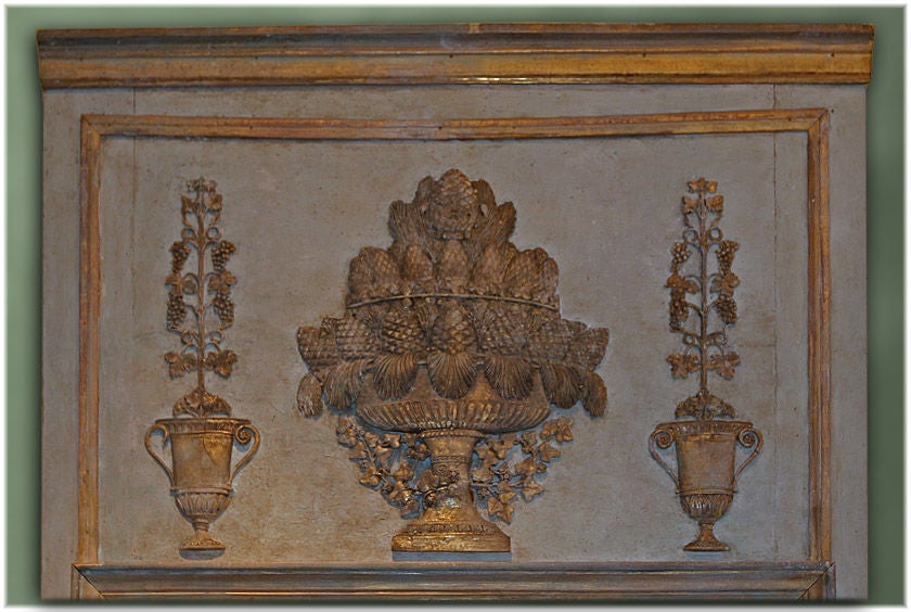 Beautiful 19th century French Empire hand-carved painted and gilded trumeau mirror. The carving of pinecones represents eternal life. The urns are adorned with grapes that represent abundance. This was commissioned for a wine chateau in South