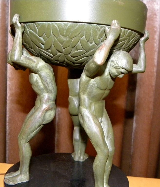 Very unique original green patinated bronze state by French artist Pierre LaFaguays.  3 men holding up urn on black Belgium marble base. The style is  very theatrical with a  point of view  maybe styled as  marquette  for an important exposition.