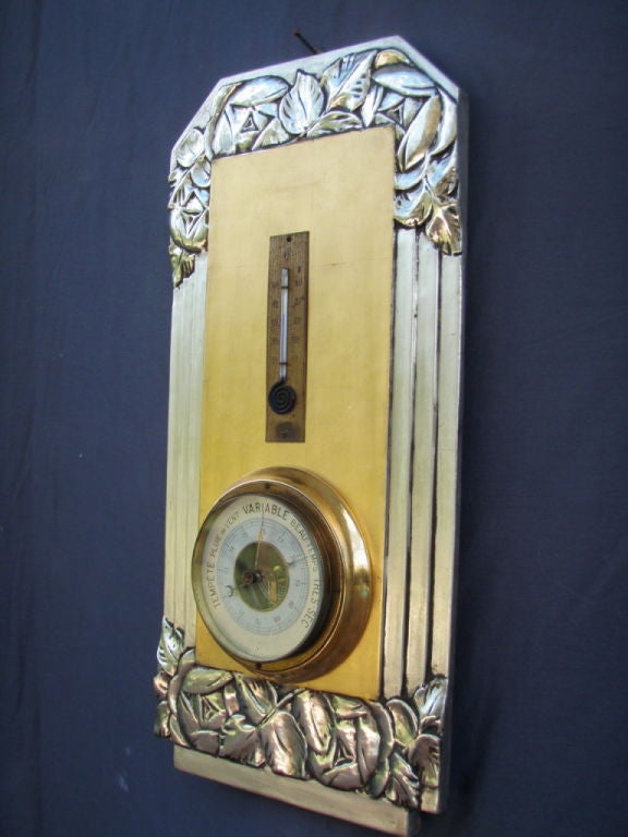 Elegant French Art Deco Barometer,  hand carved wood with gesso, finished in 24 kt yellow and 12 kt white gold.

Overall modern design with minimal carving.

Measurements:

18.5