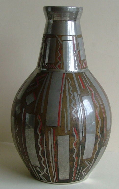 A very high quality and beautiful bronze vase having an etched acid relief design with bright nickel and red enamel decoration ,  the artist  Stlenof, would first hand make the bronze vase and then it would be nickel plated and painted with an acid