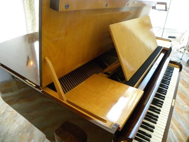 Ultra rare and magnificent French art deco piano in the manner of Dominique circa 1933.<br />
Graceful two toned mahogany maple cabinet raised on streamline supports in the most sophisticated 30's French high style.  Also accented by an unusual