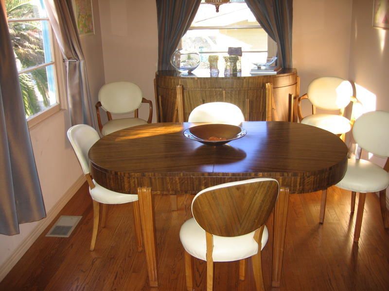 For sale is a magnificent dining suite, beautiful dimensional Macassar wood table with extravagant vertical grain. 6 fabulous fully reupholstered cream leather chairs (none with arms.) One beautifully proportioned round buffet which exactly matches