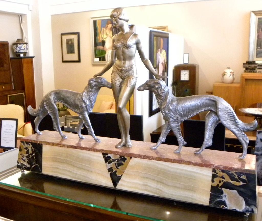 Wonderful statue representing the class art deco woman who controls and watches over the streamlined shape of the beautiful Borzoi dogs. A hard to find sculpture, this one is not signed, but I had it 2 years ago and it was signed in the marble.
