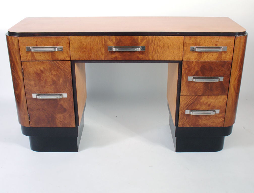Art Deco Desk, attributed to Donald Deskey for Widdicomb, circa 1930's. Beautifully burled wood drawer fronts are complimented by the black lacquer trim and nickel plated hardware. It is a versatile size and would function well as a desk, console