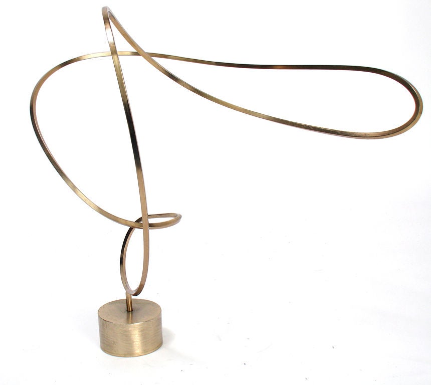 Modernist Brass Sculpture by Chicago sculptor Harold Kerr, circa 1970's. This sculpture has an elegant flowing form that looks great from every angle. It does not spin, but can be manually rotated or removed from the base. The entire sculpture and
