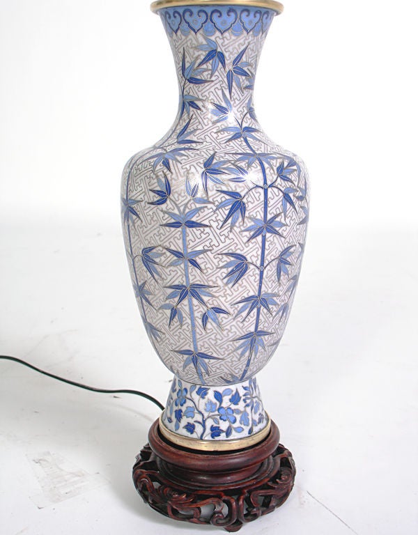 Elegant Cloisonne Lamp, probably Chinese, the lamp fittings are circa 1940's, the cloisonne vase possibly much earlier. Outstanding attention to detail executed in vibrant shades of blue. Hand carved rosewood base. The lamp measures 23.5
