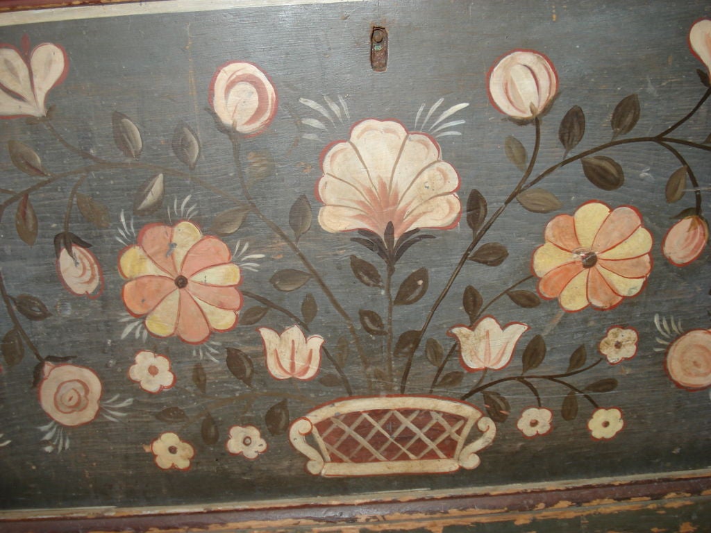 Wonderfully painted basket of flowers on a blue gray background with vermilion and white border. Dovetailed chest has original becket handles, with newish ropes, original strap hinges, and till with cover. Painted decoration done by M. DuVenet, 1950