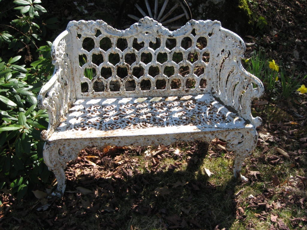 bench with arched,decorated back with scrolling arms over a pierced seat,supported on cabriole and scrolling legs. called the loop bench or white house bench as seen in the white house rose gardens. great old surface. ready for the garden.attributed