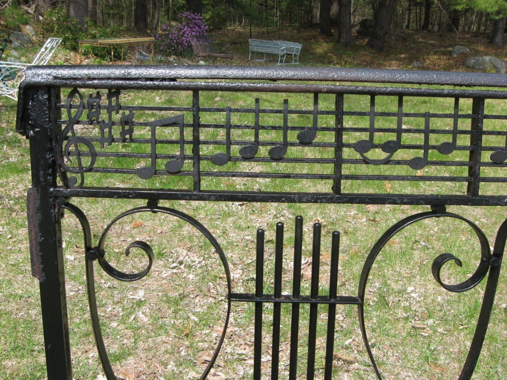 one of a kind fence featuring hand wrought lyres ,scroll work,and topped with the musical score to the song 