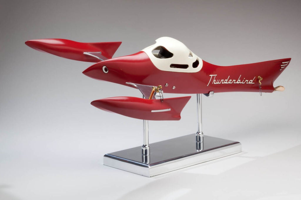 A unique and dramatic American petrol powered tethered hydroplane racing model, clearly showing the influence of the 1957 Ford Thunderbird, mounted on a mirror polished aluminum display stand.