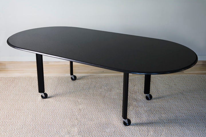 Joe D'urso granite top racetrack table on castors by Knoll
